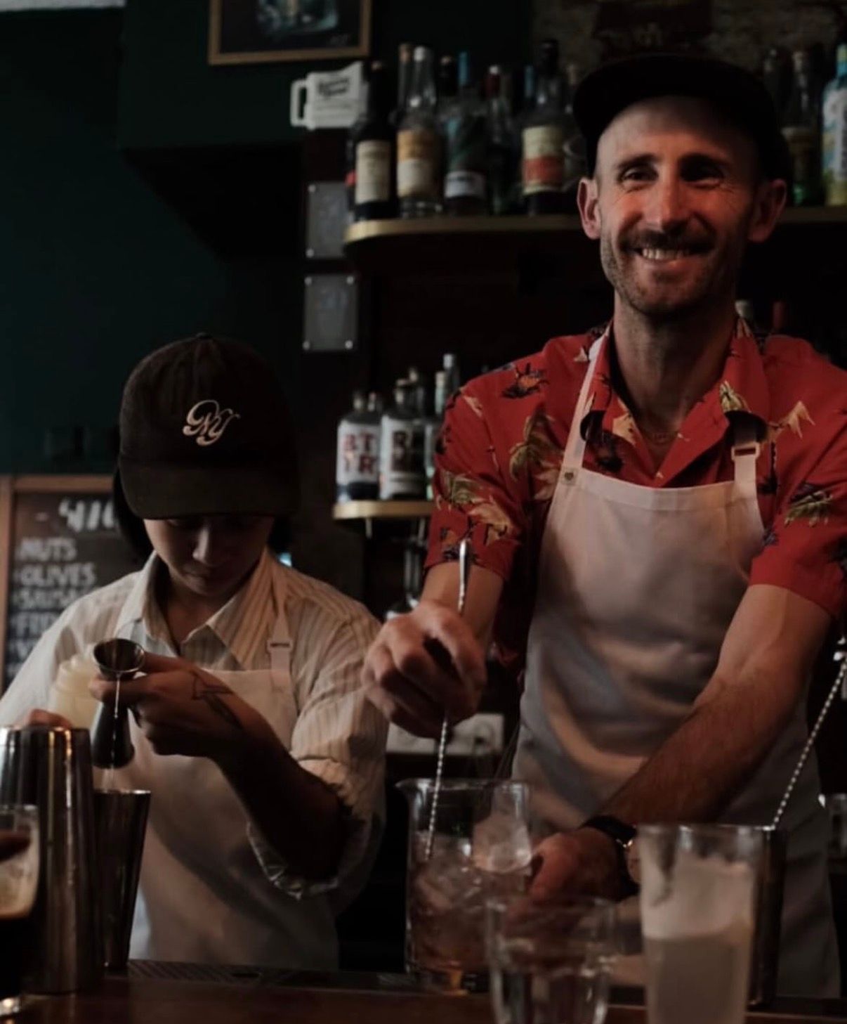 Darren Leaney smiling behind a bar
